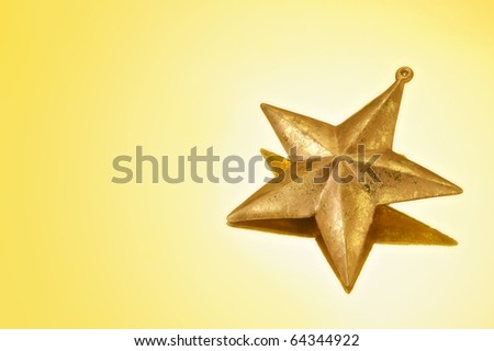 Gold Christmas Star on Gold background with copy space