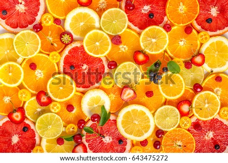 top view of  beautiful fresh trendy seamless pattern sliced mixed citrus fruits as background with different berries, concept of healthy eating, dieting 