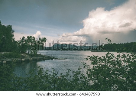 typical norway sea shore countryside landscape view with islands and trees - vintage green look