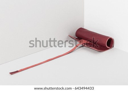 red leather pencil pocket on the grey background,