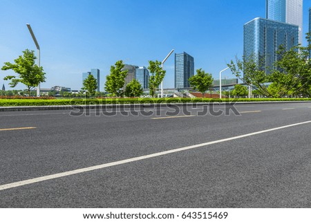 clean asphalt road with city skyline background, china.
