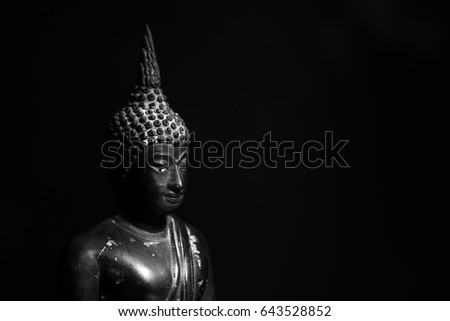 Dark tone Buddha statue, Face of Buddha.Buddha statue face close up, black background and black and white picture.