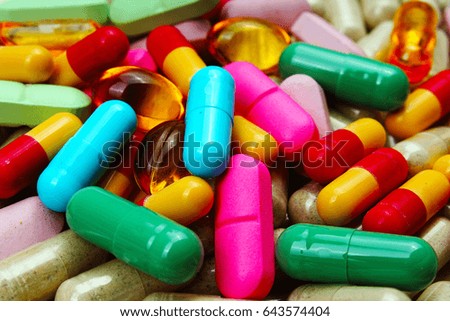 Medical or vitamin pills. Colorful medicine pills as texture. Pill pattern background. Rainbow colors. 