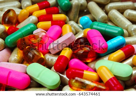 Medical or vitamin pills. Colorful medicine pills as texture. Pill pattern background. Rainbow colors. 