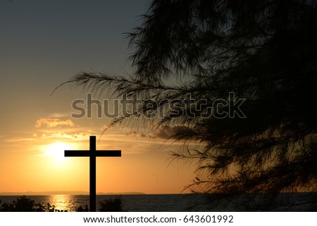 Cross silhouette, sunset background