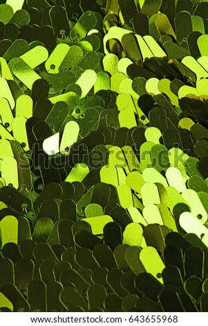 Spangle, sequin pailette background. Mirror dress material cloth texture pattern. Tailoring stitching concept. Shiny mirrored fashion fabric. Shiny clothing material sample. Creased fabric.
Green.