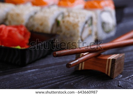 
A set of sushi on a dark wooden background. Japanese food