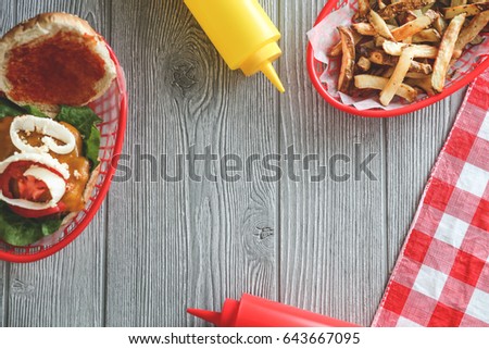 American food table background with hamburger, fries, and condiments