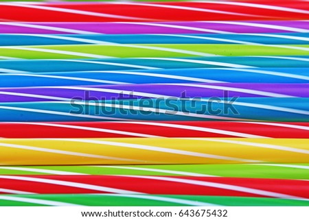 Fancy straw art background. Abstract wallpaper of colored fancy straws. Rainbow colored colorful pattern texture.
