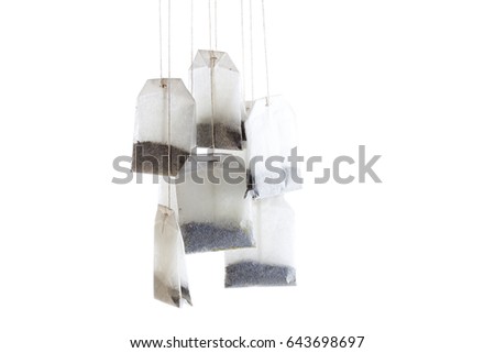 Tea bags hanging; isolated on white background