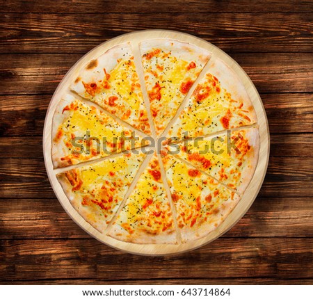 Four cheese pizza on the  wooden table. This picture is perfect  to design your restaurant menus. Visit my page. You will be able to find an image for every pizza sold in your cafe or restaurant. 

