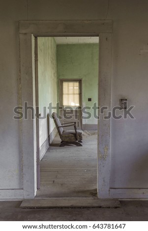 Chair leaning against a wall in an abandoned house