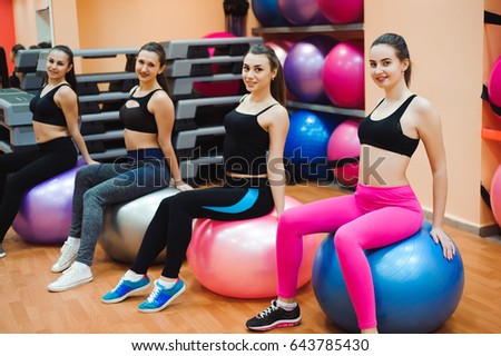 Beautiful caucasian women doing exercise with gymnastic ball.
