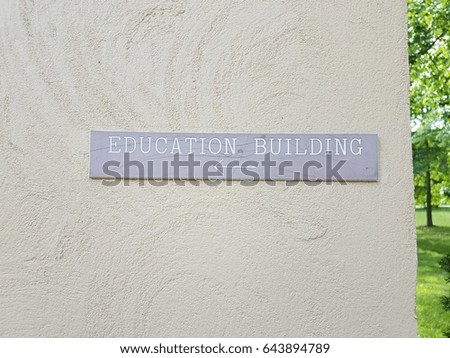 grey education building sign on wall