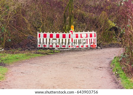 Red and White Street Barricade. Road block or construction site barrier on a road.