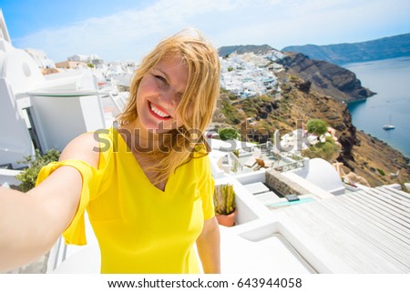 Tourist taking selfie photo in Santorini island, Greece