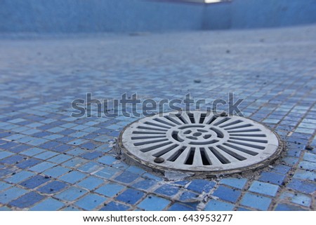 swimming pool with tiles pattern with water outlet