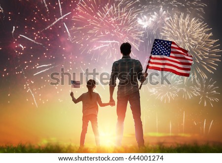 Patriotic holiday. Happy kid, cute little child girl and her father with American flag. USA celebrate 4th of July. Royalty-Free Stock Photo #644001274