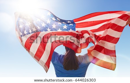 Patriotic holiday. Happy young woman with American flag. USA celebrate 4th of July. Royalty-Free Stock Photo #644026303