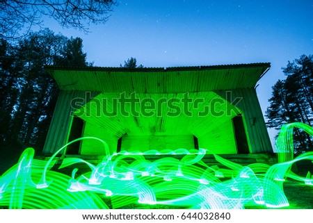Long exposure image showing stars over the old scene in forest. Light painting in the night.
Abstract lights. Nature landscape at night. 