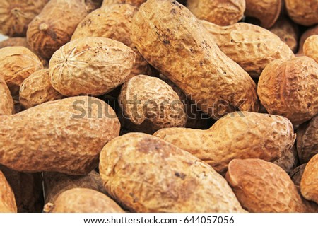 Groundnut. Peanuts without peeled shels background food photography in studio. Close up macro peanuts photo. Beautiful salted roasted peanuts pattern concept.