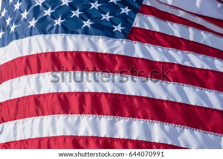 Close-up American Flag flowing, waving star and striped American flag. Ruffled USA flag. Flag of the USA blowing wind.