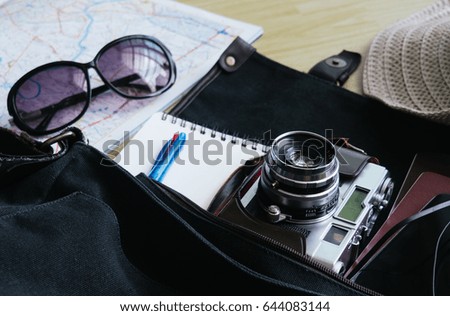retro camera film, map and Traveler's accessories for the trip on the bag ready for travel, Travel background, Tourist essentials