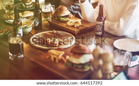 Fast food pizza and burgers on wooden table