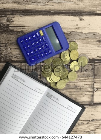 calculator, coins and notebook over white background. the conceptual of business and saving. 
