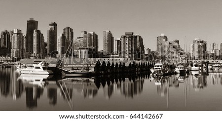 Vancouver downtown with urban buildings and boat with water reflections