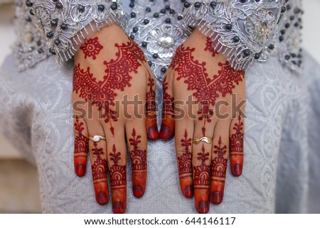 female hand, image of mehendi henna pattern. Short manicure nails. Beautiful composition, fabric background banner. Round mandala abstract flowers, flowers lilac. Close up professional art photo
