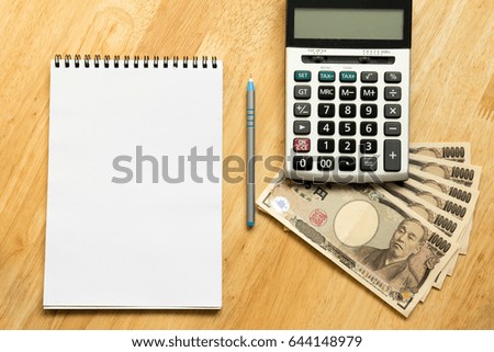White note book place on wooden table background