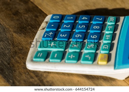 Dirty old Blue color  Calculator on Wood Background