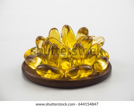 fish oil on wooden isolated on white background