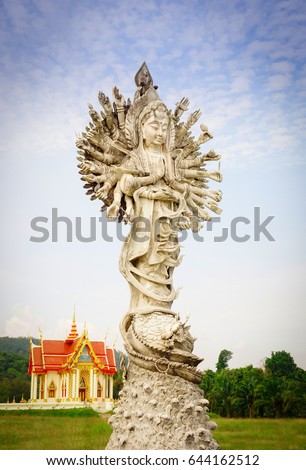    Goddess of mercy with sky background at public temple in Thailand                            