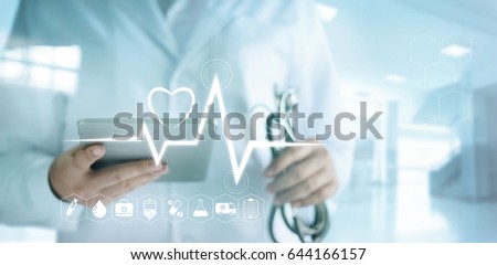 Doctor using digital tablet with medical icon and heartbeat rate in the hospital background
