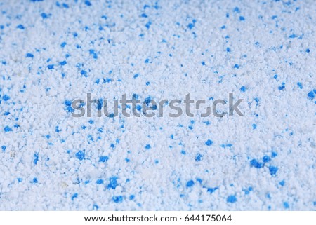 Detergent for a laundry washer. Washing powder texture pattern close up as background.