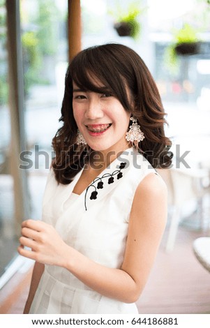 Young asian woman smiling and look at the camera at the cafe