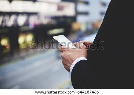 Closeup of man`s hands is holding cellphone with empty copy space screen for your advertising text message or promotional content. Closely of businessman search information in network via smart phone