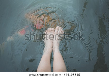 Asian child splashing around in the pool