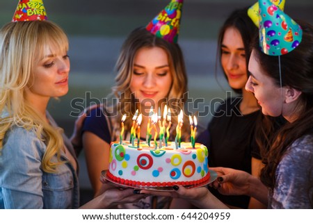 Birthday. Girls with a cake with candles.