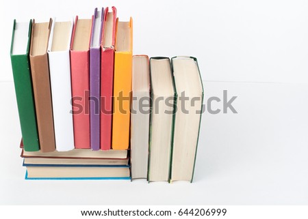 Open book, hardback colorful books on wooden table, white background. Back to school. Copy space for text. Education business concept