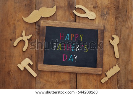 top view image of fathers day composition with wooden shape tools and blackboard