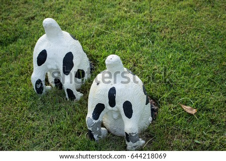 Two Cow's bottom doll on the grass for gardening