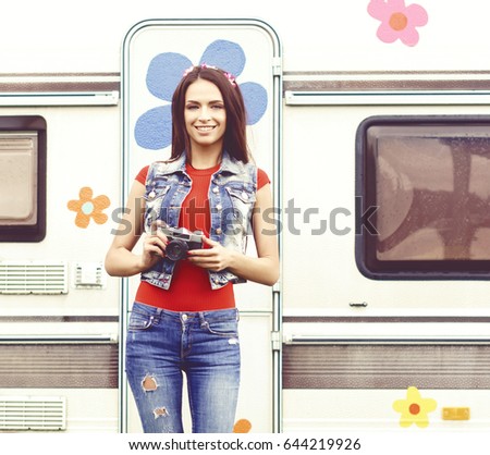 Young, beautiful hipster girl with vintage camera outdoors at summer. Vacation, holiday, concept.