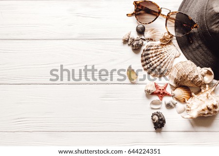 shells sunglasses hat on white background with space for text, summer vacation concept, top view. summertime holiday picture, wanderlust and travel. flat lay