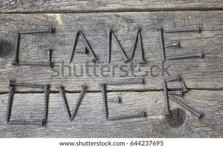 the inscription of screws on a wooden table