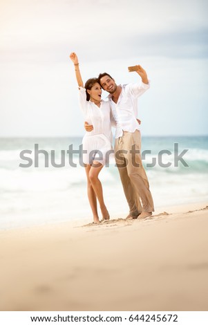 Young couple making selfie on beach