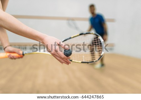 Couple play squash game in indoor training club Royalty-Free Stock Photo #644247865