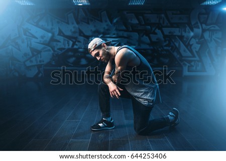 Breakdance performer posing in dance studio